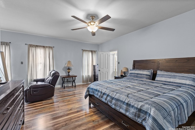 bedroom with ceiling fan and dark hardwood / wood-style flooring