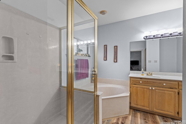 bathroom featuring vanity, separate shower and tub, and hardwood / wood-style floors