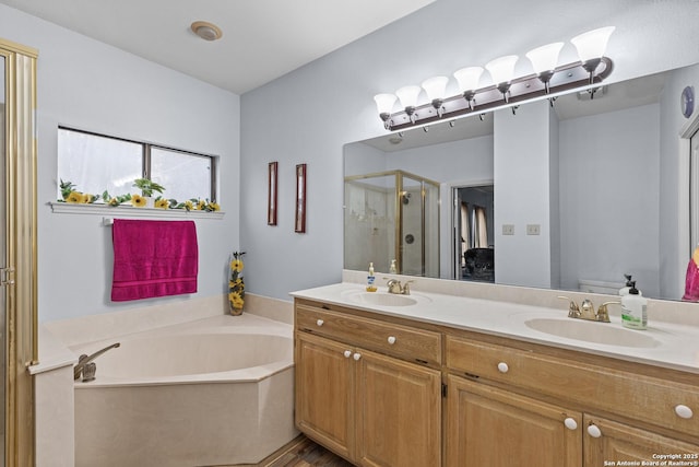 full bathroom featuring shower with separate bathtub, vanity, and toilet