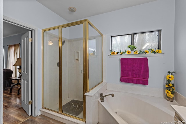 bathroom with plus walk in shower, hardwood / wood-style floors, and vanity