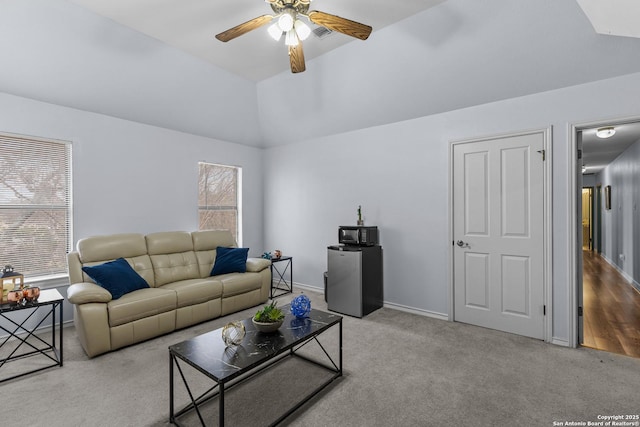 carpeted living room featuring vaulted ceiling and ceiling fan