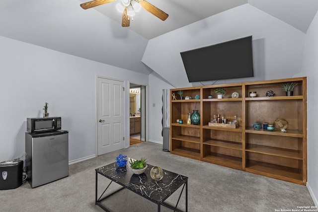 living room featuring lofted ceiling, light carpet, and ceiling fan