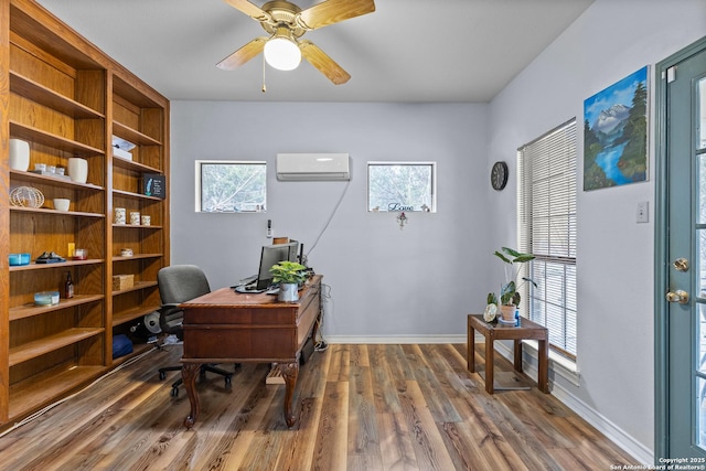 office area with dark hardwood / wood-style flooring, ceiling fan, and a wall unit AC