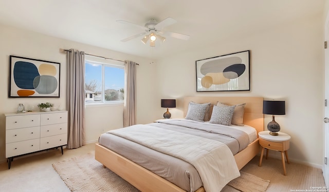 bedroom featuring light colored carpet and ceiling fan