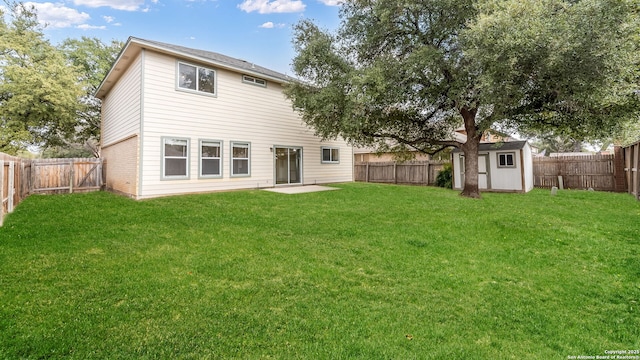 rear view of property with a shed and a lawn