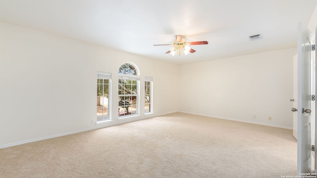 spare room featuring ceiling fan and light colored carpet