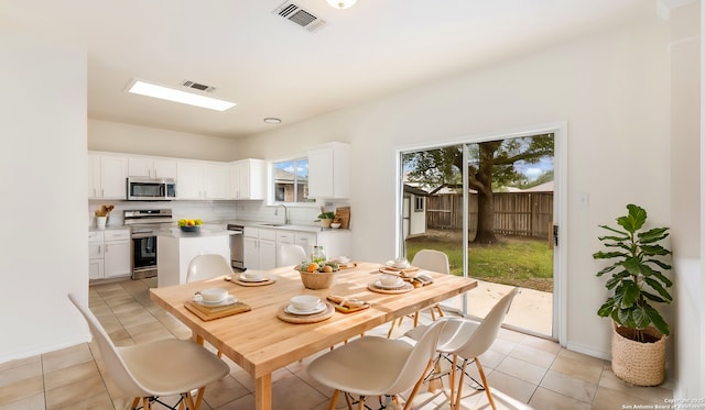 dining room featuring light tile patterned flooring and sink