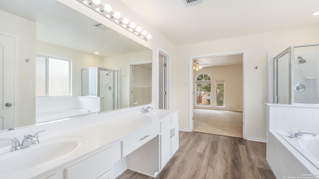 bathroom featuring vanity, shower with separate bathtub, and hardwood / wood-style floors