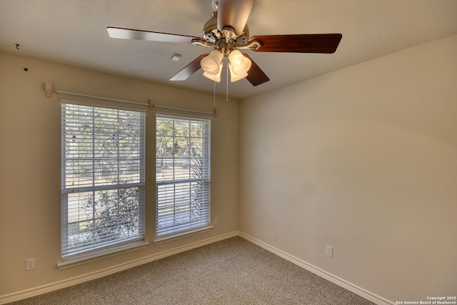 spare room featuring carpet flooring and ceiling fan