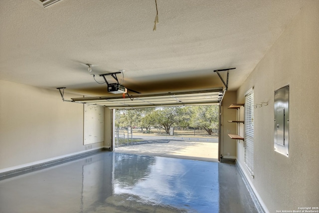 garage featuring electric panel and a garage door opener