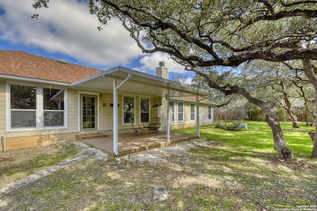 exterior space with a front yard and a patio area