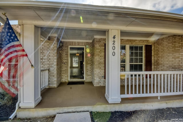 view of exterior entry featuring a porch