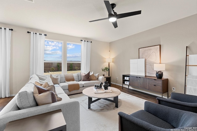 living room featuring hardwood / wood-style flooring and ceiling fan