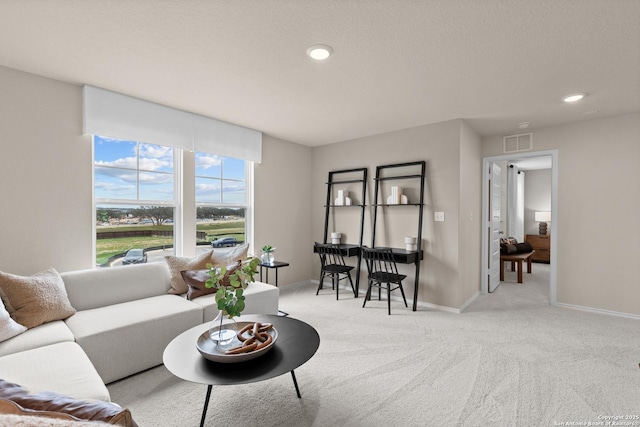 living room with light carpet and a textured ceiling