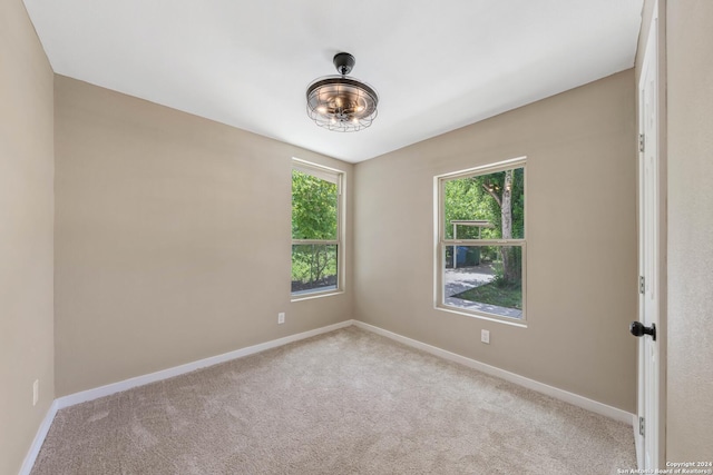 spare room with light colored carpet