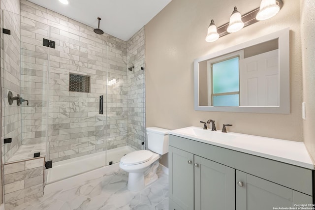 bathroom featuring vanity, toilet, and a shower with shower door