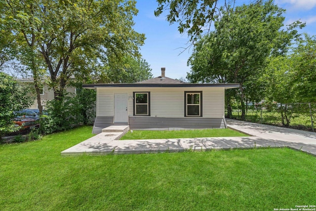 rear view of property with a lawn