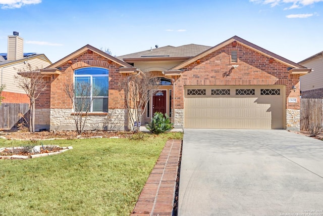 view of front of home featuring a garage and a front lawn