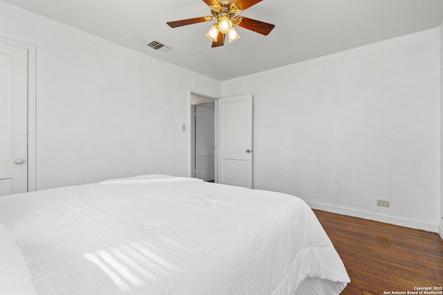 bedroom with dark wood-type flooring and ceiling fan