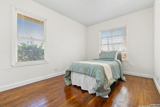 bedroom with dark hardwood / wood-style floors