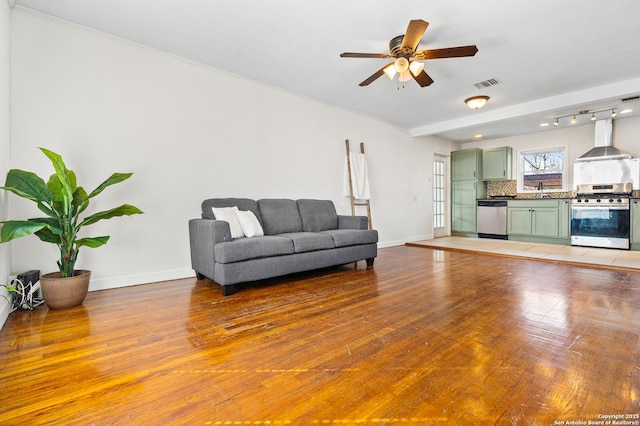 living room with ceiling fan and hardwood / wood-style floors