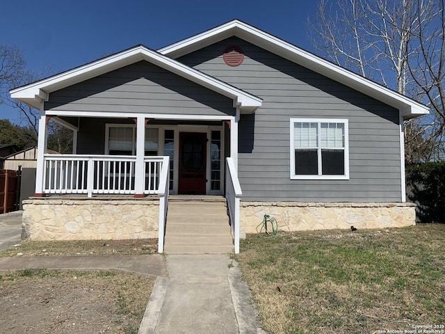 bungalow-style house with a porch and a front yard