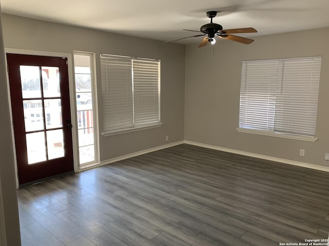 spare room featuring dark wood-type flooring and ceiling fan