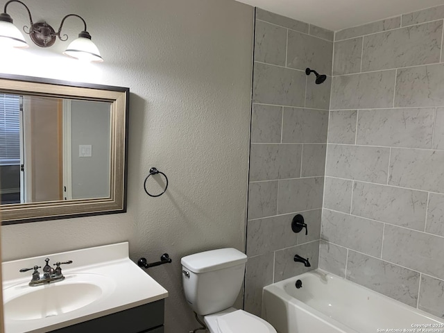 full bathroom with tiled shower / bath combo, vanity, and toilet