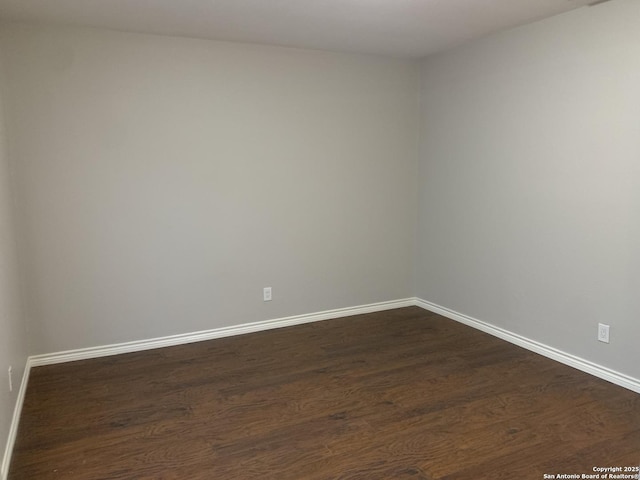 unfurnished room with dark hardwood / wood-style floors