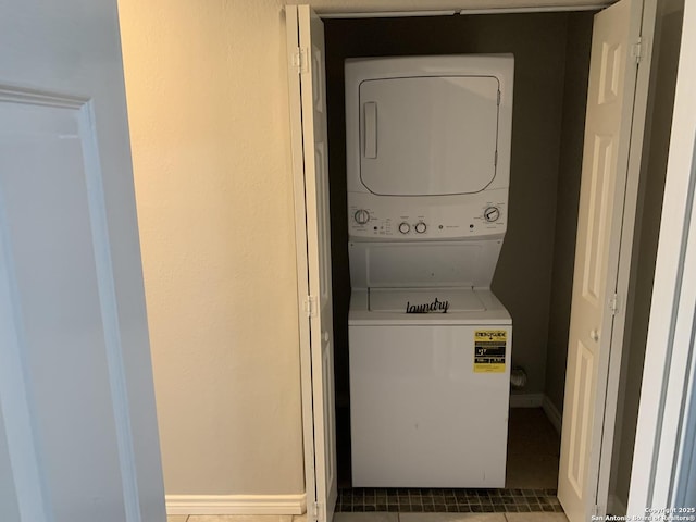 clothes washing area featuring stacked washer / drying machine