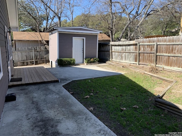 view of yard featuring a storage unit and a patio area