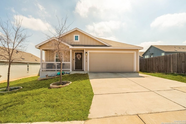 view of front of home featuring a porch, a garage, and a front yard