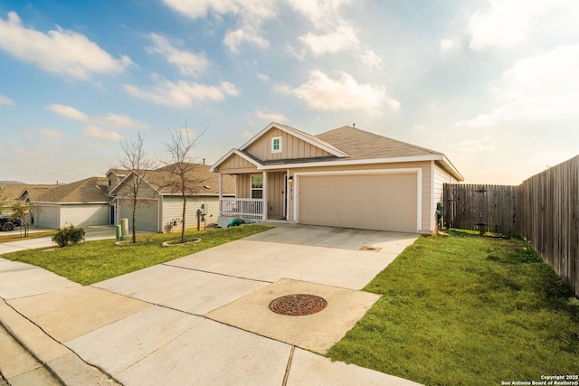 view of front of house with a garage, a front yard, and a porch