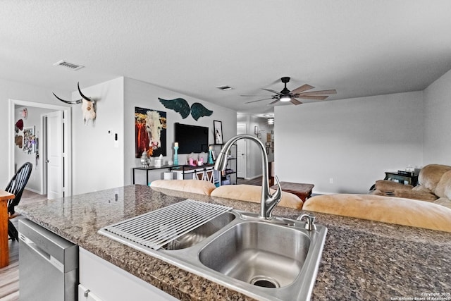 kitchen featuring sink, white cabinetry, light hardwood / wood-style flooring, stainless steel dishwasher, and ceiling fan