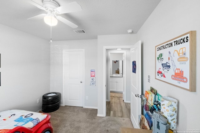 bedroom with light carpet and ceiling fan