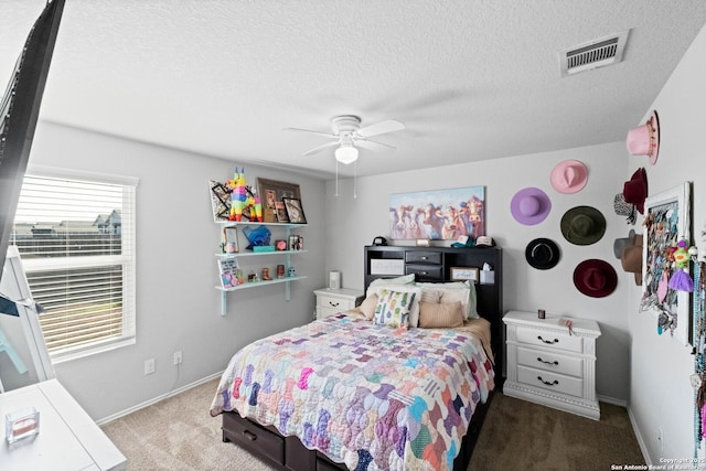 carpeted bedroom with ceiling fan and a textured ceiling