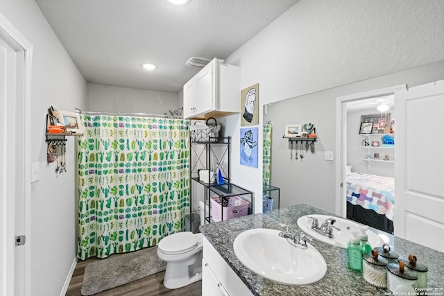 bathroom with hardwood / wood-style flooring, vanity, toilet, and a shower with shower curtain