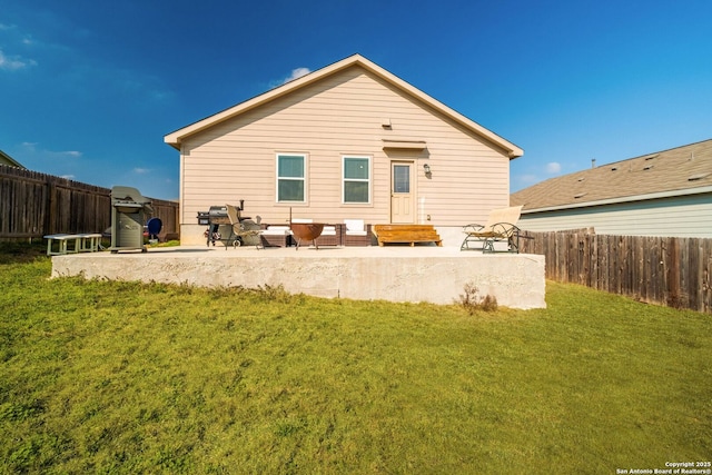 back of house featuring a patio area and a lawn