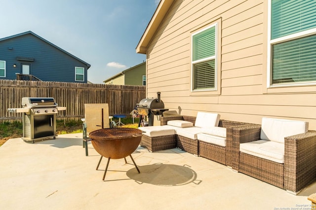 view of patio / terrace with a grill and an outdoor living space with a fire pit