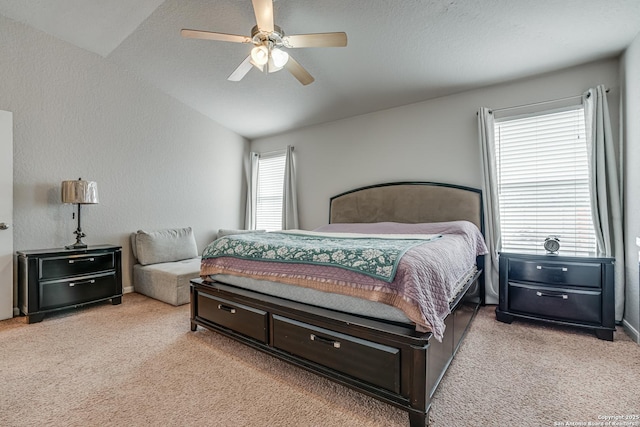 carpeted bedroom with vaulted ceiling and ceiling fan