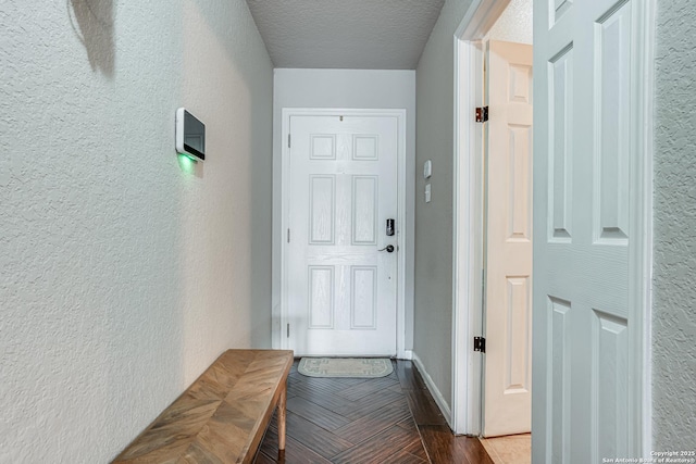 corridor featuring hardwood / wood-style flooring and a textured ceiling