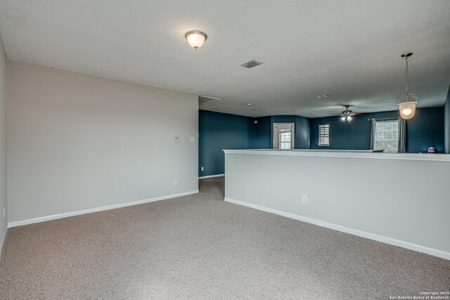 carpeted empty room with a textured ceiling