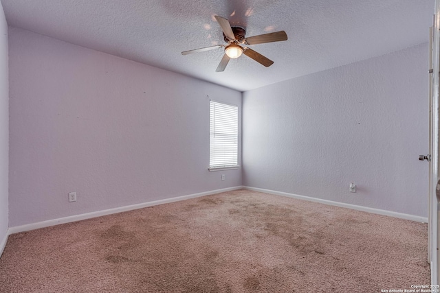 empty room with ceiling fan, carpet, and a textured ceiling