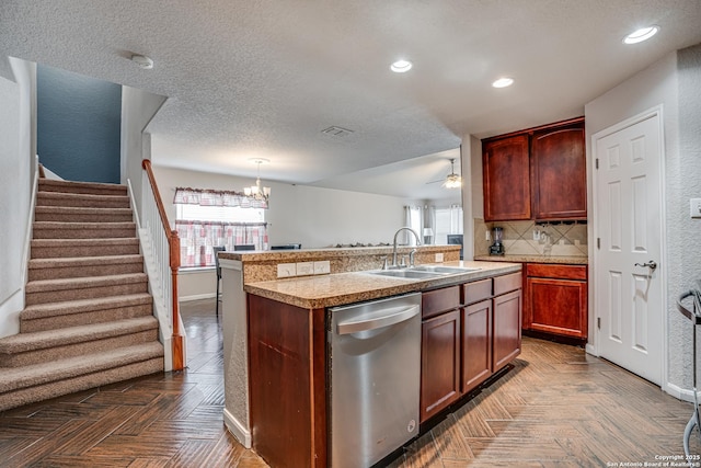 kitchen featuring pendant lighting, dark parquet floors, dishwasher, sink, and a center island with sink