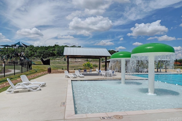 view of swimming pool featuring a playground, a gazebo, pool water feature, and a patio