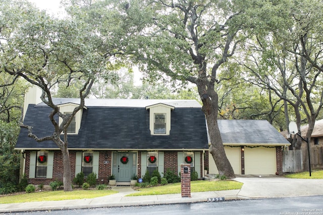 new england style home with a garage