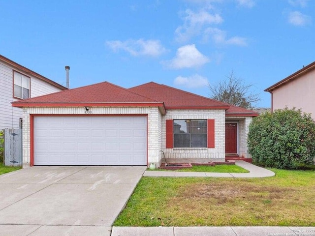 view of front of house with a garage and a front lawn