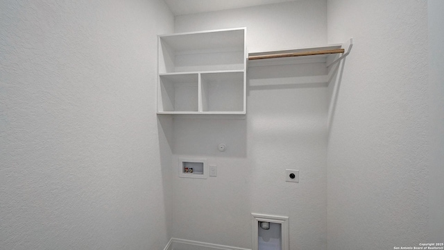 2623 Vistablue Ln, San Antonio, TX 78245 - laundry room featuring hookup for a washing machine, electric dryer hookup, gas dryer hookup, baseboards, and a textured wall