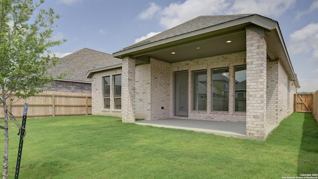2623 Vistablue Ln, San Antonio, TX 78245 - rear view of property with brick siding, a patio area, and roof with shingles