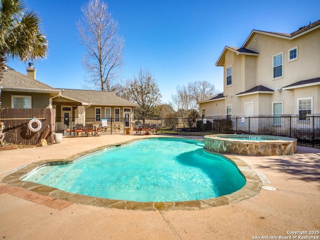 view of swimming pool with an in ground hot tub and a patio